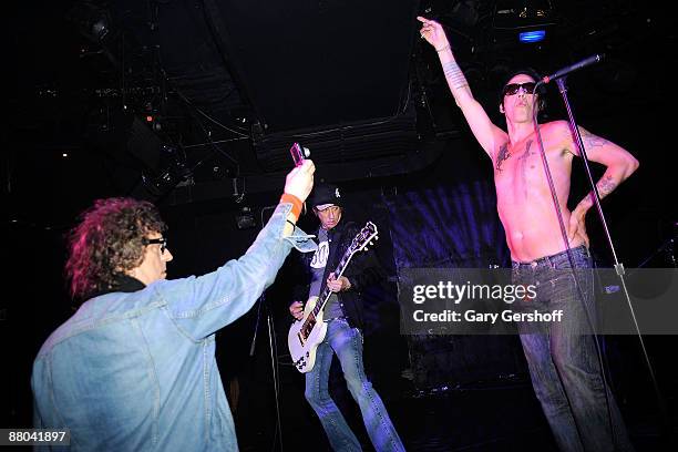 Rock photographer Mick Rock , takes pictures of rock musician Michael H. As he performs live on stage for invited guests at the "Raw Power Redux"...