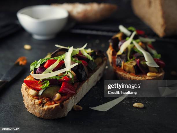 roasted vegetable bruschetta with goat cheese and pine nuts - bread knife stock pictures, royalty-free photos & images
