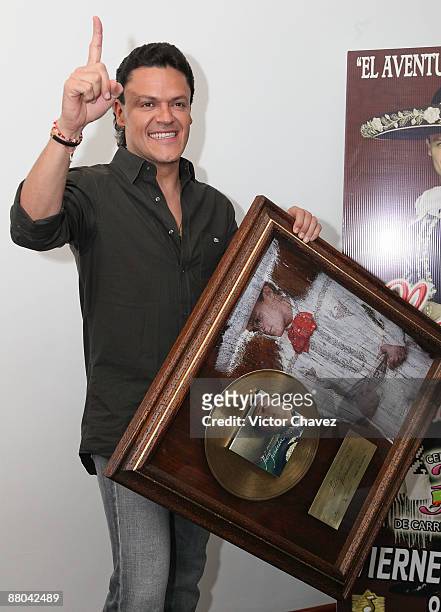 Singer Pedro Fernandez handling a gold disc for more than 5,000 sales of his album "Dime Mi Amor" at Universal Music on May 28, 2009 in Mexico City,...