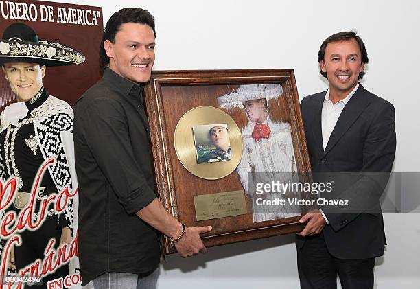 Singer Pedro Fernandez handling a gold disc for more than 5,000 sales of his album "Dime Mi Amor" at Universal Music on May 28, 2009 in Mexico City,...