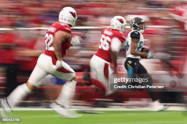 Wide receiver Keelan Cole of the Jacksonville Jaguars runs with the football after a reception past inside linebacker Karlos Dansby and free safety...