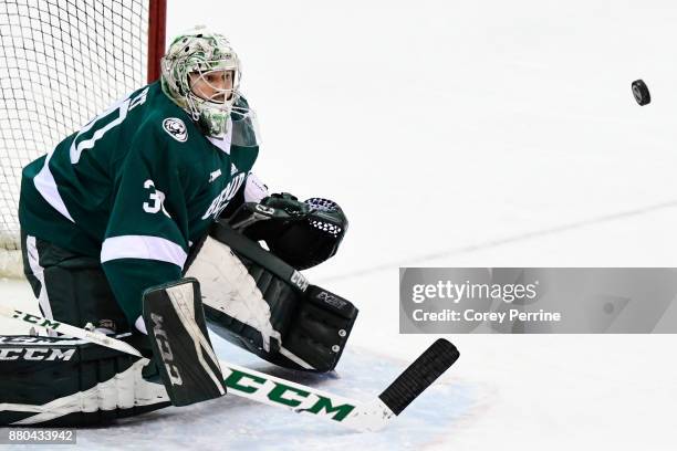 Jack Burgart of the Bemidji State Beavers eyes a shot on goal against the Princeton Tigers during the first period at Hobey Baker Rink on November...