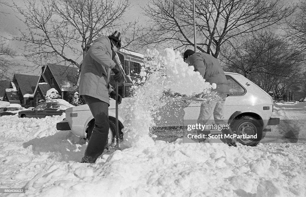 Blizzard Of 1978 NYC, Two Men Digging Out A Stranded Vehicle