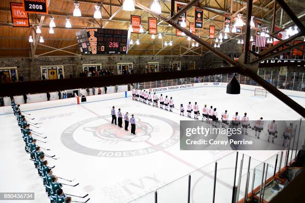 The Bemidji State Beavers and the Princeton Tigers stand for the national anthem before the game at Hobey Baker Rink on November 24, 2017 in...