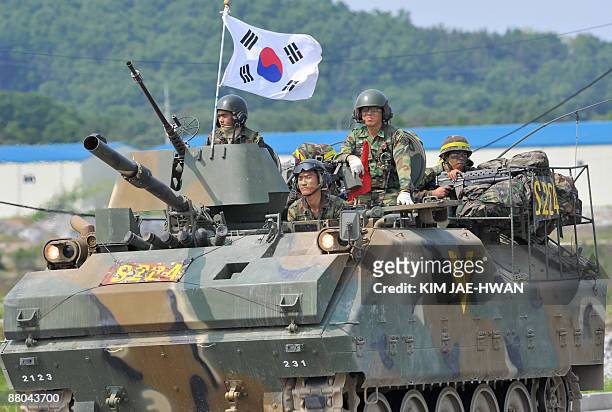 South Korean Army soldiers are seen atop armoured vehicles during a drill at the boder town of Paju on May 29, 2009. North Korea warned on May 27 of...