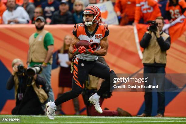 Wide receiver Alex Erickson of the Cincinnati Bengals looks up to catch a pass for a 29 yard second quarter touchdown against the Denver Broncos at...