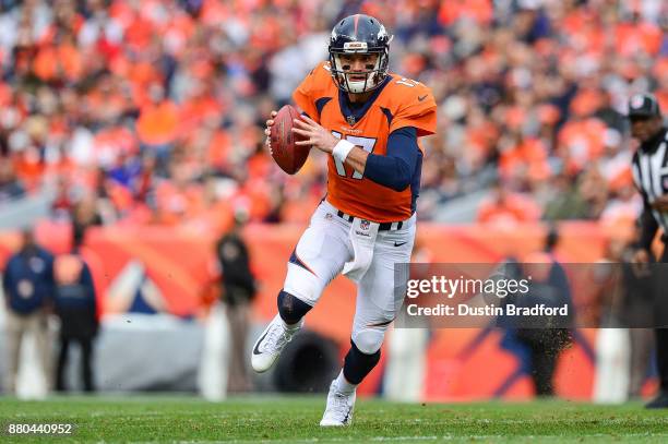 Quarterback Brock Osweiler of the Denver Broncos rushes against the Cincinnati Bengals in the first quarter of a game at Sports Authority Field at...