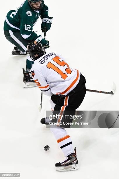 Max Véronneau of the Princeton Tigers handles the puck against Dylan McCrory of the Bemidji State Beavers during the first period at Hobey Baker Rink...