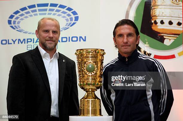 Coach thomas Schaaf of Bremen and coach Bruno Labbadia of Leverkusen pose with the trophy during a press conference prior to the German cup final at...