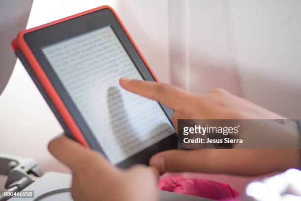 young woman using digital tablet - e reader stock pictures, royalty-free photos & images