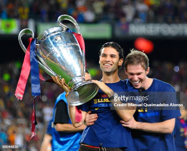 Rafael Marquez holds the UEFA Champions League trophy with Aleksander Hleb at the Nou Camp stadium the day after Barcelona won the UEFA Champions...