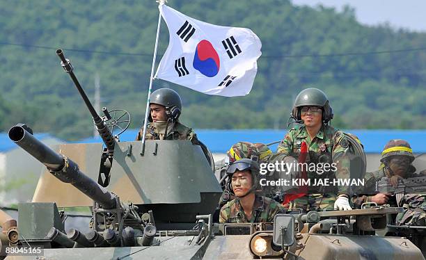 South Korean Army soldiers are seen atop armoured vehicles during a drill at the boder town of Paju on May 29, 2009. North Korea warned on May 27 of...