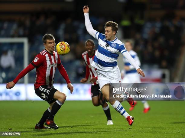 Queens Park Rangers' Luke Freeman and Brentford's Andreas Bjelland battle for the ball during the Sky Bet Championship match at Loftus Road, London.