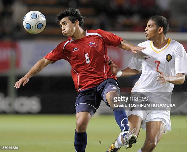 Chilean forward Edson Puch eyes on the ball beside Belgian midfielder Faris Haroun during the Kirin Cup football tournament in Chiba on May 29, 2009....