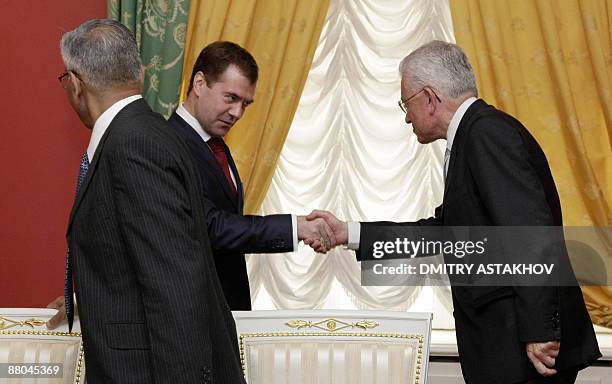 Russian President Dmitry Medvedev shakes hands with Brazilian Minister of Strategic Affairs Roberto Mangabeira Unger in Moscow on May 29, 2009....
