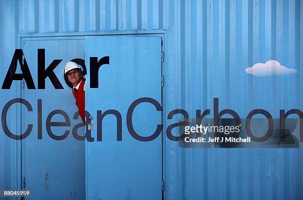 Scientist stands beside a new carbon capture test unit at Longanet power station on May 29, 2009 in Longanet, Scotland. The new technology being...