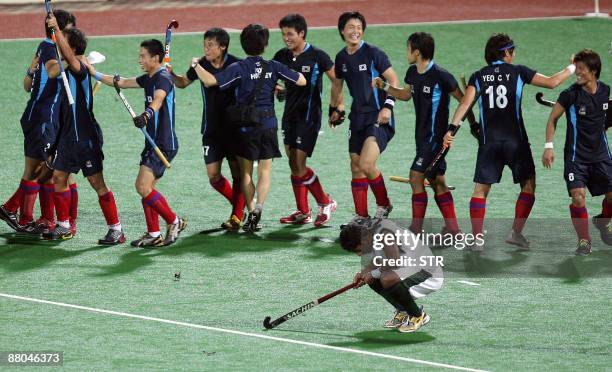 South Korean field hockey players celebrate after defeating Pakistan during their final match at the Asia Cup field hockey tournament in Kuantan,...