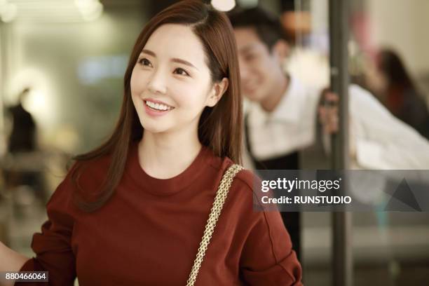 woman leaving hair salon and looking very happy with her hair - purses and body care stock pictures, royalty-free photos & images