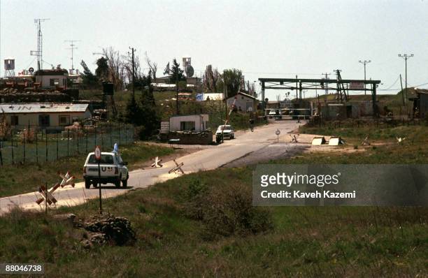 Vehicle heads towards the crossing point between Syria and Israel near the ruined town of Quneitra in the United Nations Disengagement Observer Force...