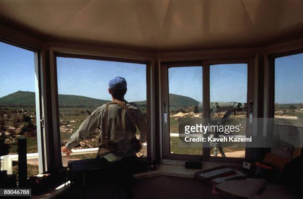 Observer watches the Golan Heights from the ruined town of Quneitra in the United Nations Disengagement Observer Force Zone in south-western Syria,...