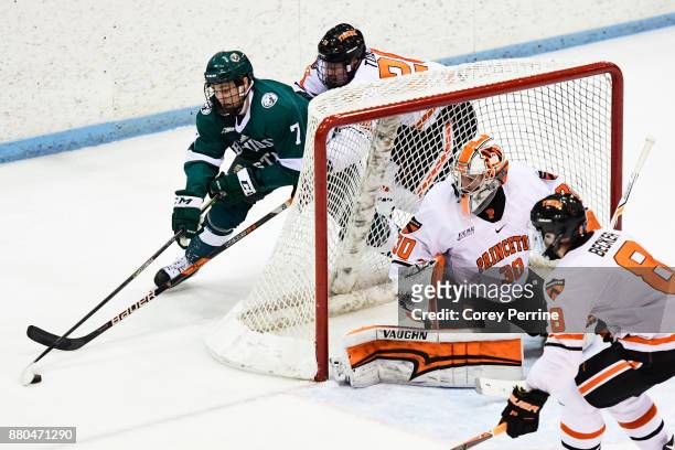 Roo of the Bemidji State Beavers tires to hook around and score as Derek Topatigh of the Princeton Tigers defends and teammates Ryan Ferland and Max...