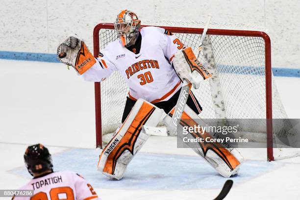 Ryan Ferland of the Princeton Tigers catches a shot on goal from the Bemidji State Beavers during the third period at Hobey Baker Rink on November...