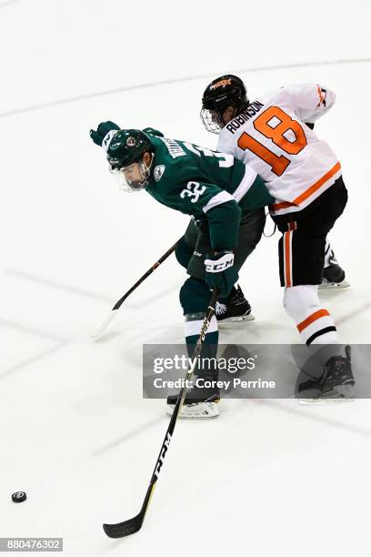 Zach Whitecloud of the Bemidji State Beavers fends off Eric Robinson of the Princeton Tigers during the third period at Hobey Baker Rink on November...