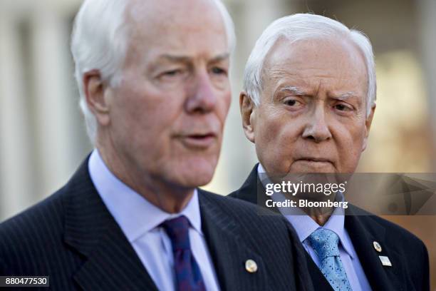 Senator Orrin Hatch, a Republican from Utah and chairman of the Senate Finance Committee, right, listens as Senate Majority Whip John Cornyn, a...