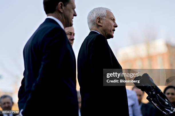 Senator Orrin Hatch, a Republican from Utah and chairman of the Senate Finance Committee, right, speaks to members of the media after a meeting with...