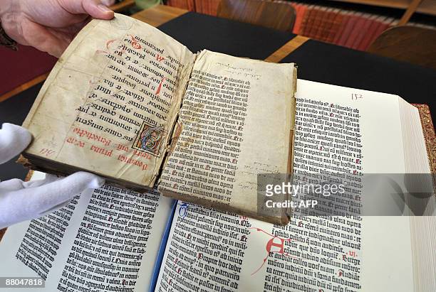Person shows on May 29, 2009 in Colmar, northeastern France shows pages from the Gutenberg Bible discovered in a library by a library assistant, who...