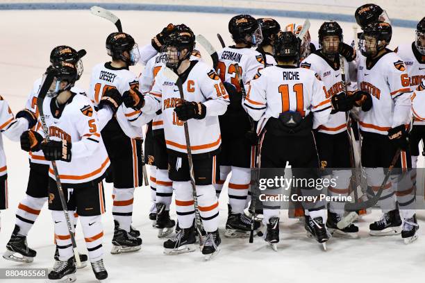 Eric Robinson of the Princeton Tigers shakes hands with teammates after the game against the Bemidji State Beavers at Hobey Baker Rink on November...