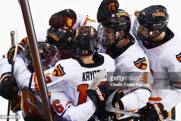 Josh Teves of the Princeton Tigers hugs teammates after the last goal of the game is scored against the Bemidji State Beavers during the third period...