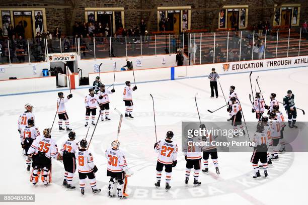 The Princeton Tigers ceremonially raise their sticks to slap the ice after the game at Hobey Baker Rink on November 24, 2017 in Princeton, New...