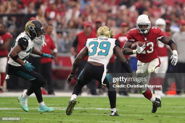 Running back Adrian Peterson of the Arizona Cardinals rushes the football against cornerback Jalen Ramsey and free safety Tashaun Gipson of the...