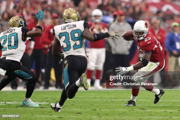 Running back Adrian Peterson of the Arizona Cardinals rushes the football against cornerback Jalen Ramsey and free safety Tashaun Gipson of the...