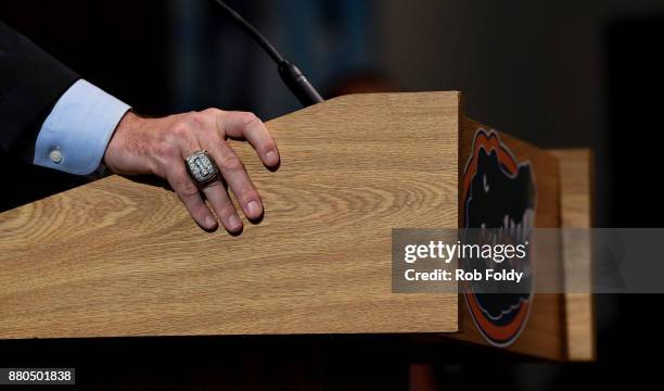 Detailed view of a National Championship ring worn by Florida Gators head football coach Dan Mullen as he speaks during an introductory press...