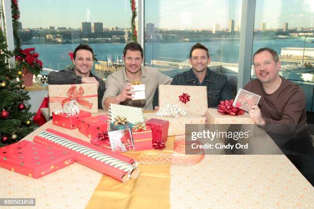 Drew Lachey, Nick Lachey, Jeff Timmons and Justin Jeffre of 98 Degrees and Mastercard get in the holiday spirit, tapping Masterpass to purchase...