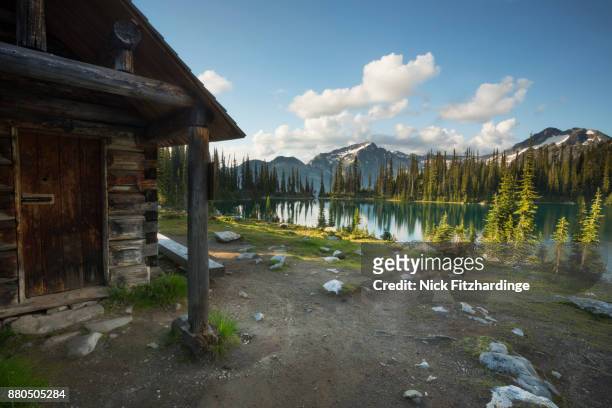 an old federal heritage building for mt revelstoke national park wardens built in 1928 sits on the edge of eva lake, british columbia, canada - hut stock pictures, royalty-free photos & images