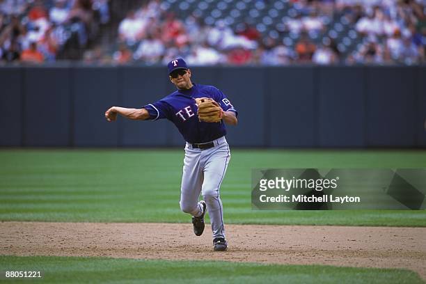 Alex Rodriguez of the Texas Rangers fields a ground ball during a baseball game against the Baltimore Orioles on May 24, 2001 at Camden Yards in...