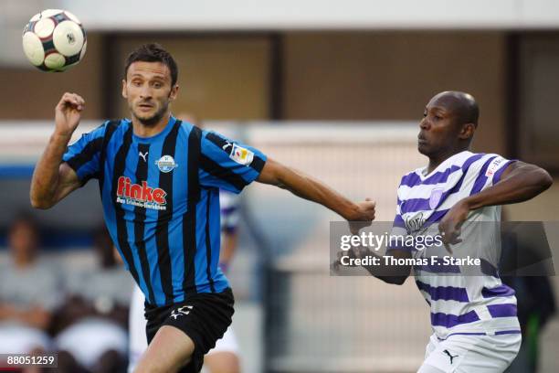 Jovan Damjanovic of Paderborn and Darlington Omodiagbe of Osnabrueck tackle for the ball during the Second Bundesliga Play Off match between SC...