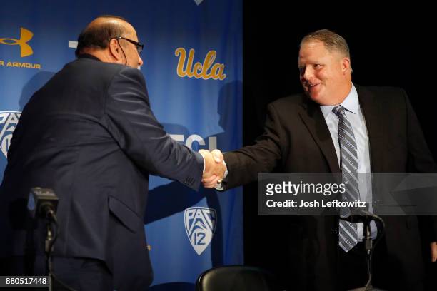 Director of Athletics Dan Guerrero and Chip Kelly shake hands after a press conference introducing Kelly as the new UCLA Football head coach on...