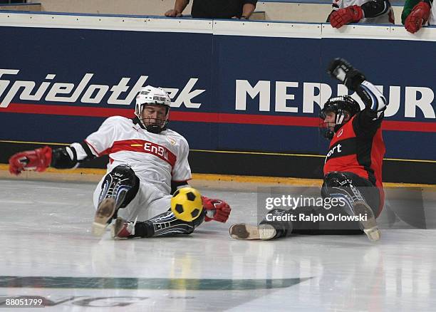 Franz Wohlfahrt of VFB Stuttgart and Rudi Bommer of Eintracht Frankfurt play ice football during the 'Deutscher Eisfussball Pokal 2009' 'German Ice...