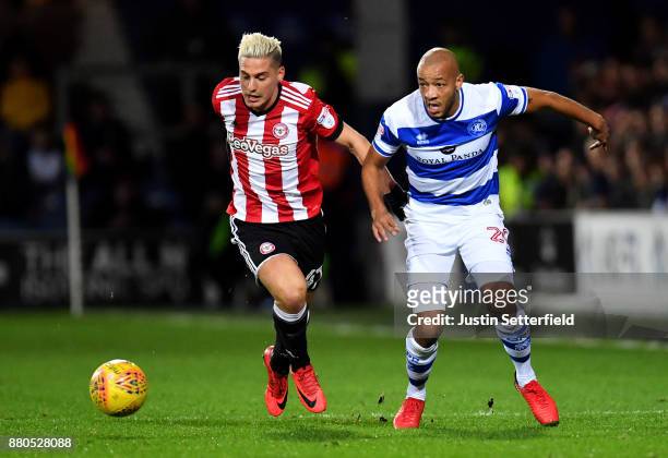 Sergi Canos of Brentford and Alex Baptiste of Queens Park Rangers during the Sky Bet Championship match between Queens Park Rangers and Brentford at...