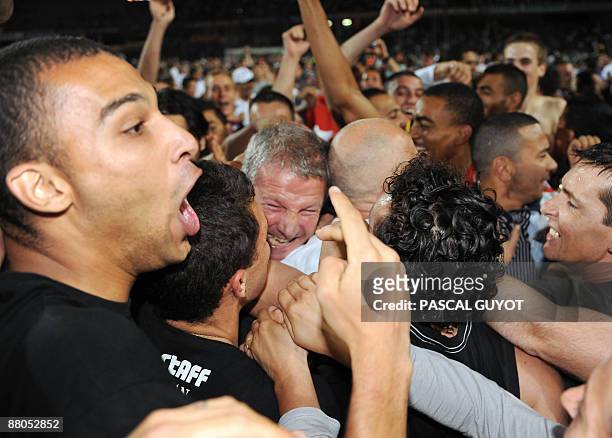 Montpellier's coach Rolland Courbis hugs supporters at the end of the French L2 football match Montpellier vs. Strasbourg, on May 29, 2009 at the la...