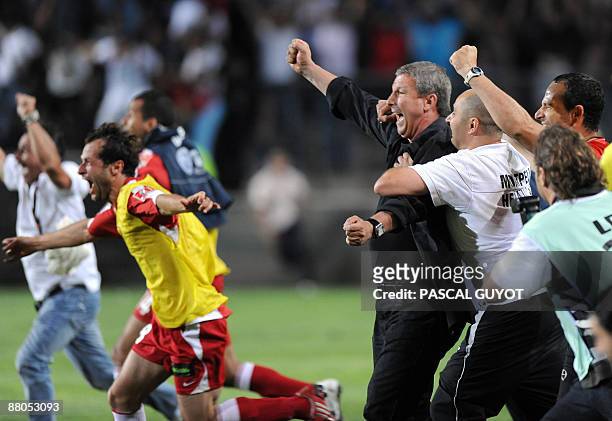 Montpellier's coach Rolland Courbis reacts along with players and staff members at the end of the French L2 football match Montpellier vs Strasbourg,...