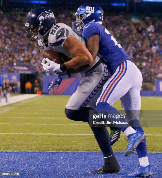 Jimmy Graham of the Seattle Seahawks hauls in a touchdown reception against Eli Apple of the New York Giants on October 22, 2017 at MetLife Stadium...