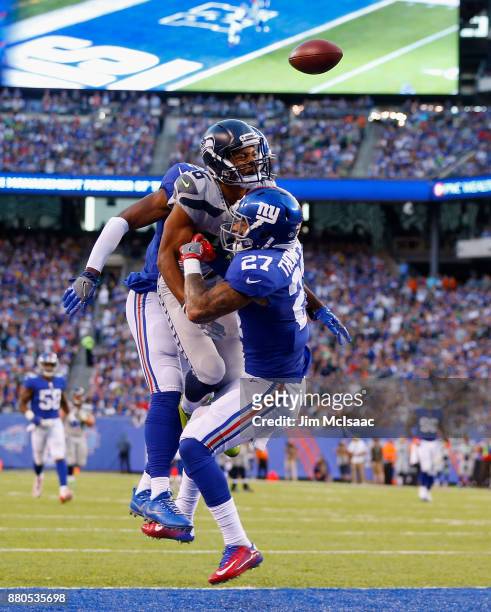 Eli Apple and Darian Thompson of the New York Giants in action against Tyler Lockett of the Seattle Seahawks on October 22, 2017 at MetLife Stadium...