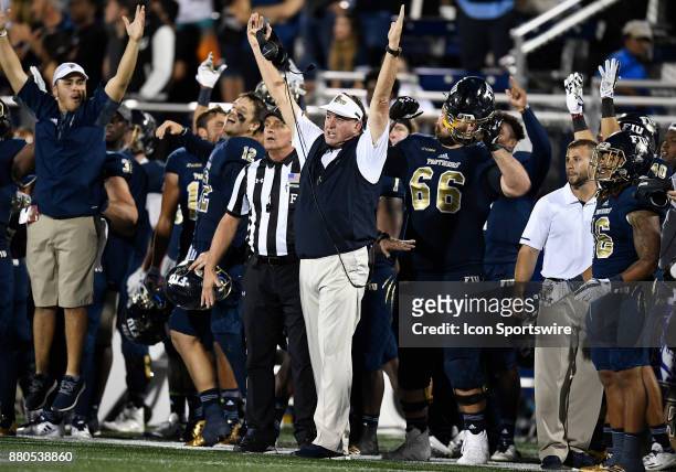 Florida International University Head Coach Butch Davis (RL_171124 signals touchdown when he learns that a penalty was not on his team on a scoring...