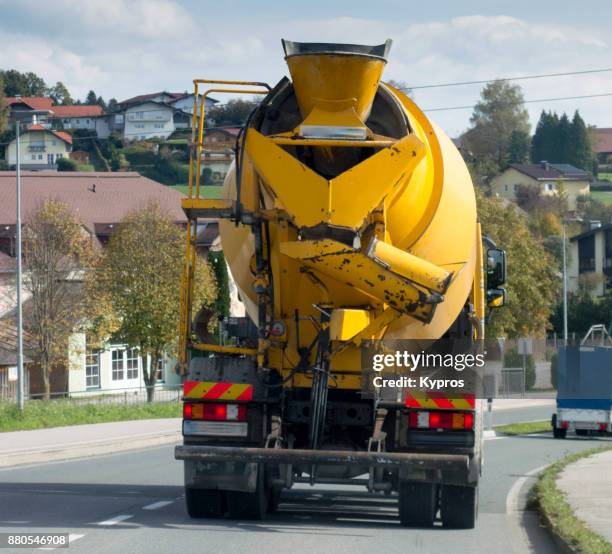 europe, austria, salzburg area, 2017: view of cement truck driving on road - betonmischer stock-fotos und bilder