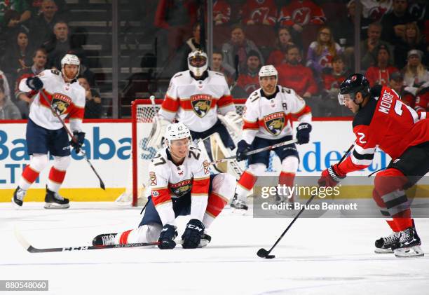 Nick Bjugstad of the Florida Panthers hits the ice to block a pass from John Moore of the New Jersey Devils during the first period at the Prudential...